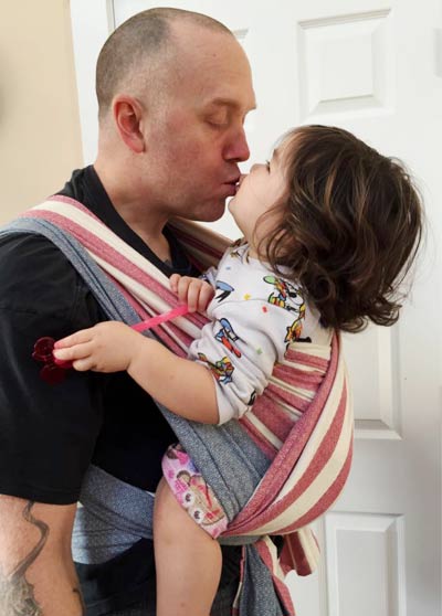 Babywearing Dad with baby close enough to kiss